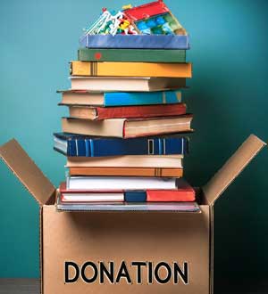 donation-box Books and games stacked in a box