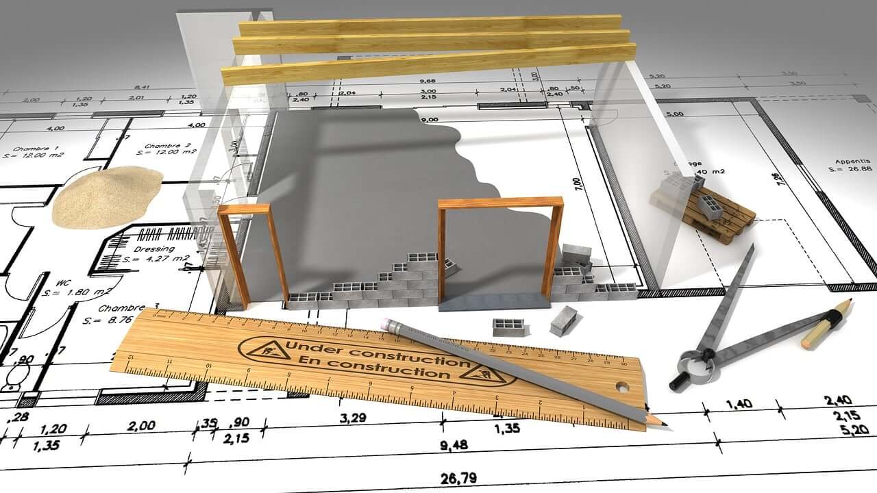 Rendering Suggestion of an architect's rendering showing partial white and grey walls, two wooden door frames, and and rule and pencil set on top of a blue print.