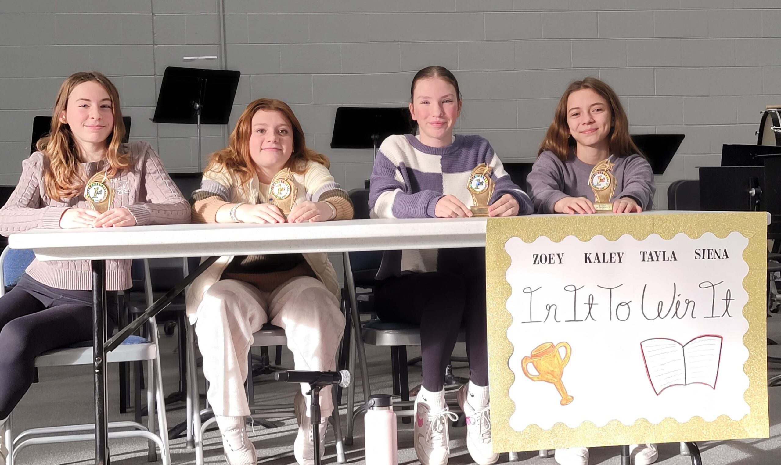 In It to Win It ETMS students with their Battle of the Books trophies.