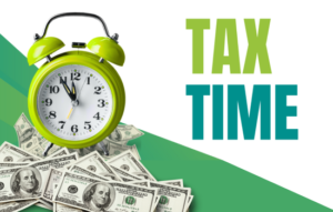 Lime green alarm clock on top of bill of cash with "Tax Time" on right of image.