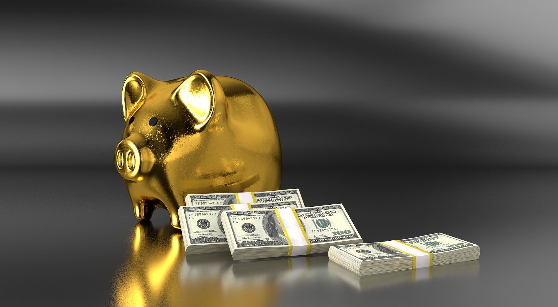 Gold piggy bank with bundled paper money