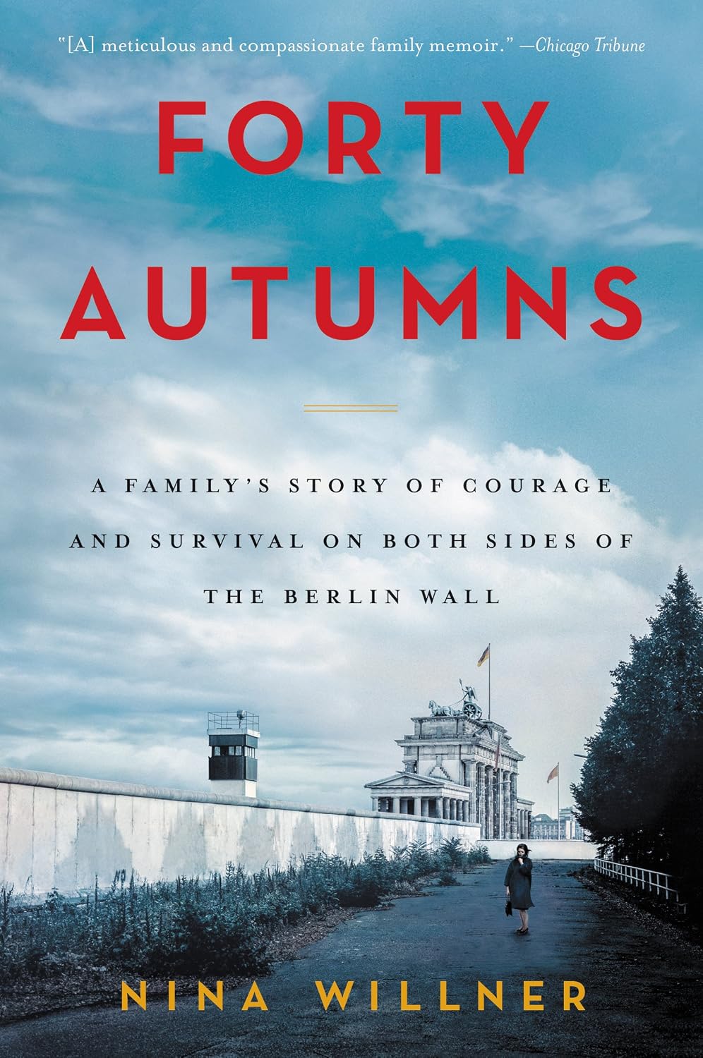A picture of the Berlin Wall set against a blue, cloudy sky.